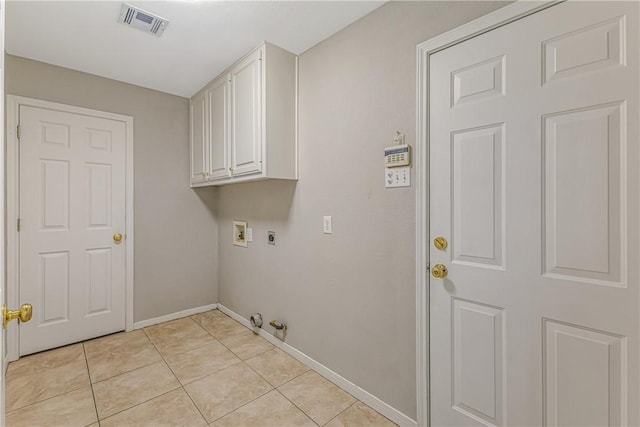 laundry room with gas dryer hookup, cabinets, light tile patterned floors, and hookup for a washing machine