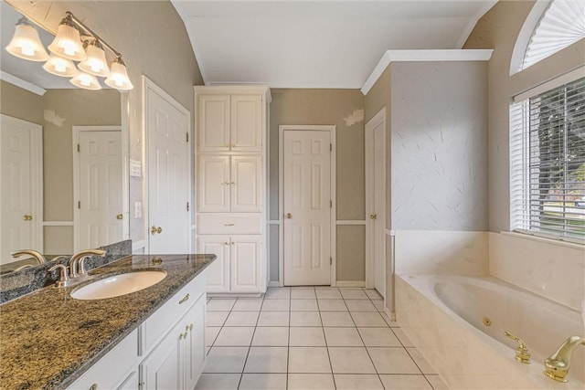 bathroom featuring vanity, crown molding, tiled tub, tile patterned flooring, and lofted ceiling