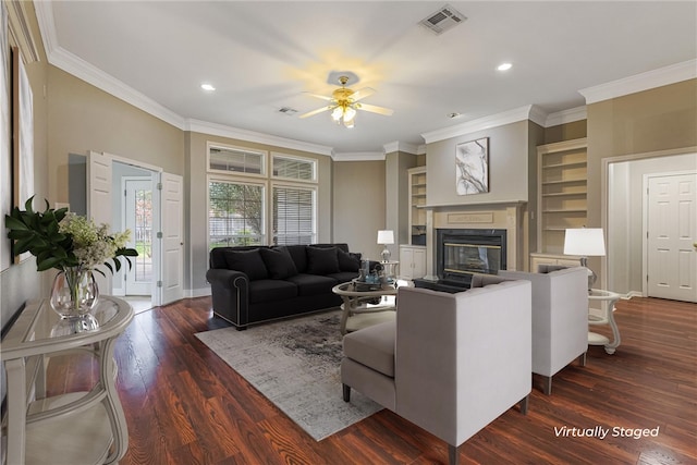 living room featuring ceiling fan, built in features, dark hardwood / wood-style floors, and ornamental molding