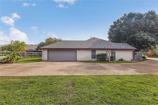 view of side of home with a lawn and a garage