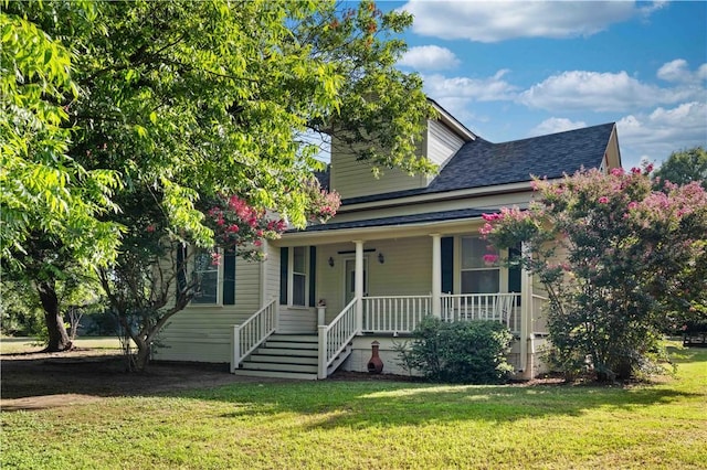 view of front facade with a front lawn and covered porch