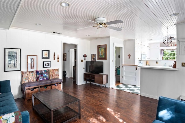 living room featuring ceiling fan and dark hardwood / wood-style flooring