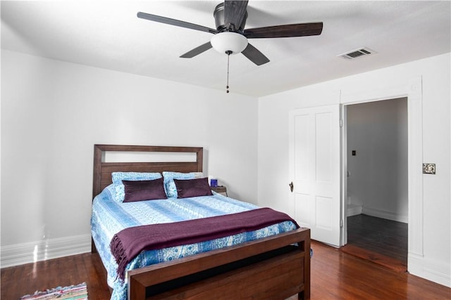 bedroom with ceiling fan and dark hardwood / wood-style floors