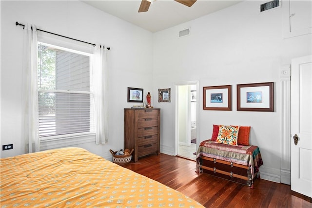 bedroom featuring ensuite bath, ceiling fan, and dark wood-type flooring