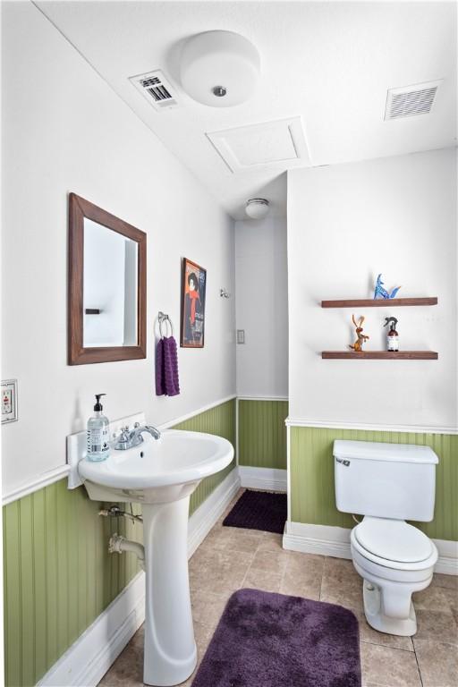 bathroom featuring tile patterned flooring and toilet