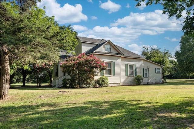 view of property exterior with a lawn