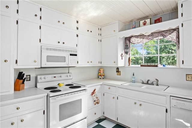 kitchen featuring white cabinets, white appliances, and sink