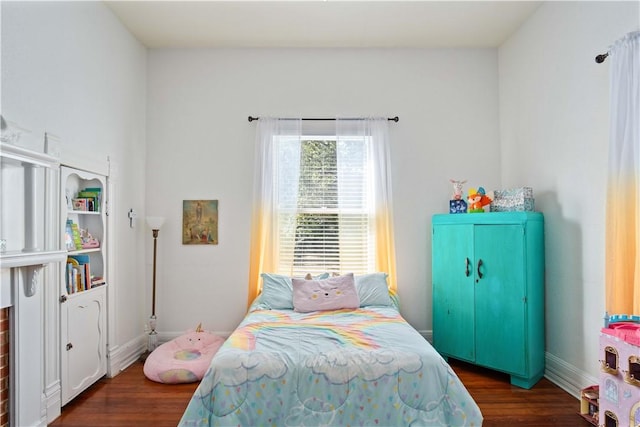 bedroom with dark wood-type flooring