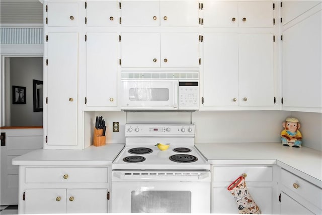 kitchen with white cabinetry and white appliances