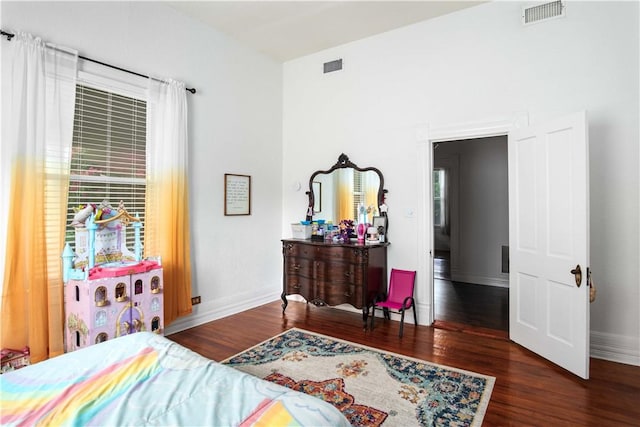 bedroom with dark wood-type flooring