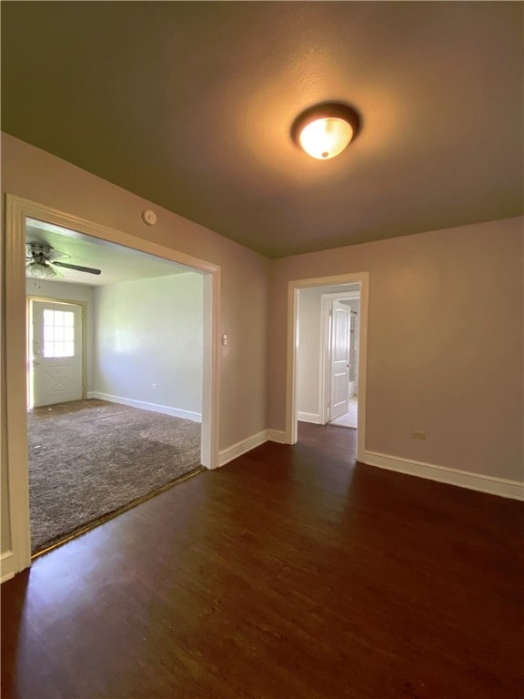 spare room featuring ceiling fan and dark hardwood / wood-style flooring