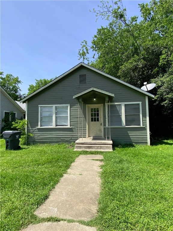 bungalow with a front lawn