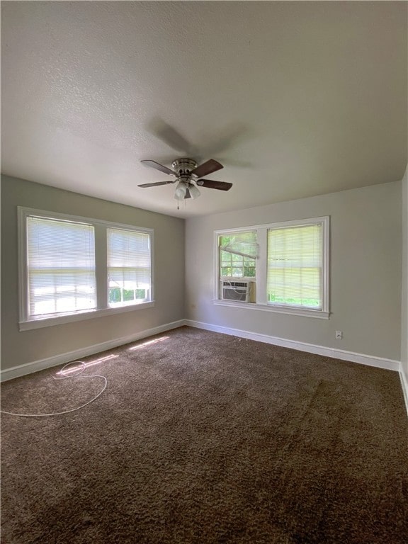 carpeted spare room featuring ceiling fan, cooling unit, and a textured ceiling