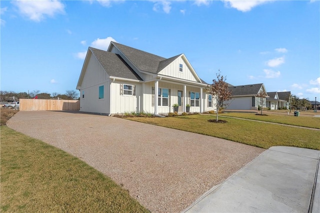 view of front of house with covered porch and a front lawn