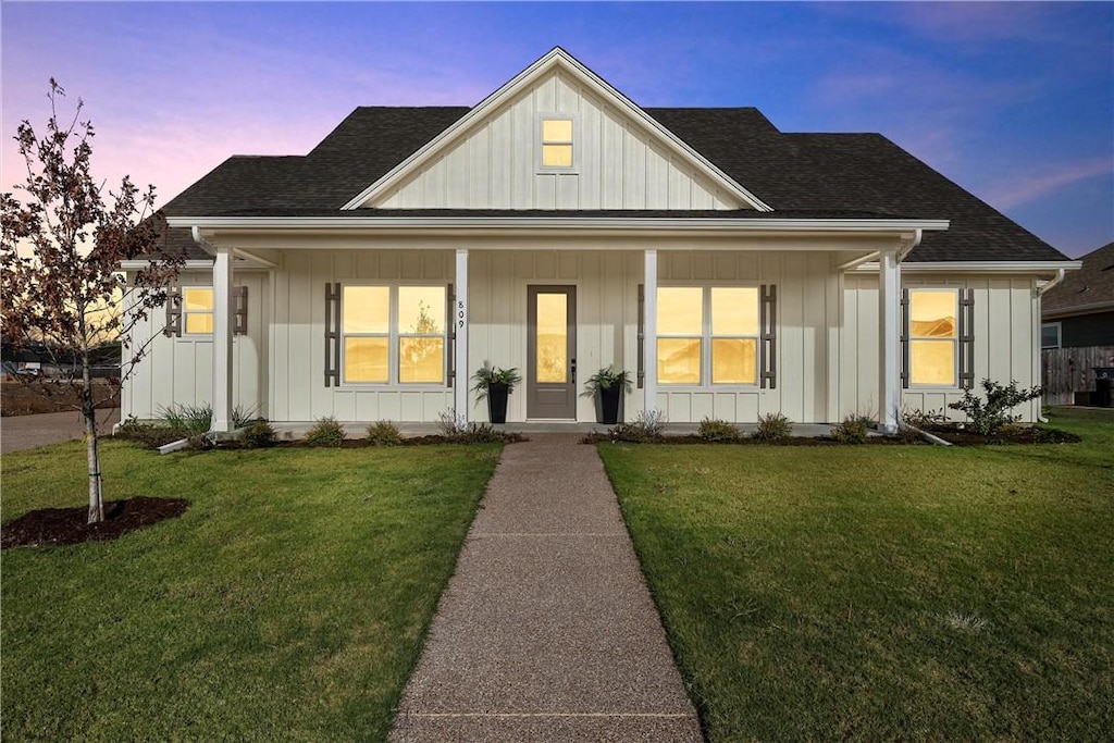 view of front facade featuring a porch and a lawn