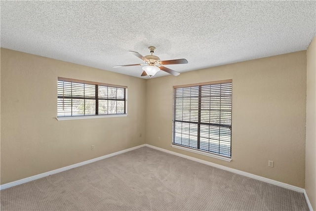 carpeted spare room with ceiling fan and a textured ceiling