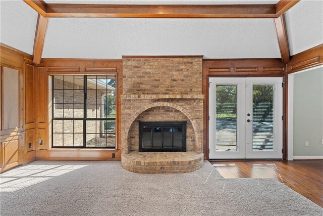 unfurnished living room with hardwood / wood-style flooring, a textured ceiling, and a wealth of natural light