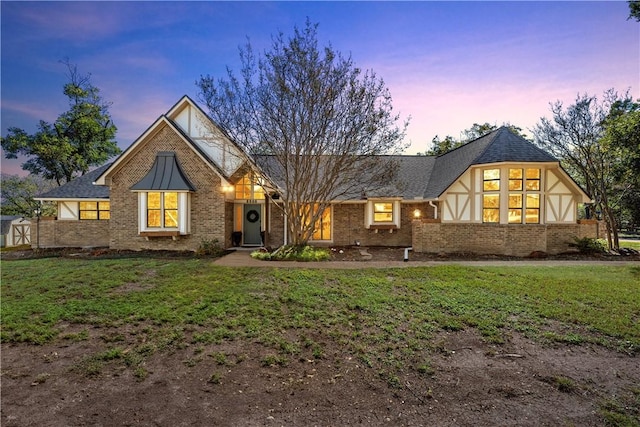 tudor home with a yard