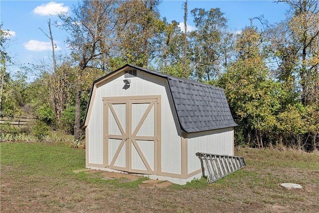 view of outbuilding featuring a yard