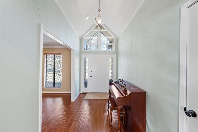 entryway with lofted ceiling, dark hardwood / wood-style flooring, and ornamental molding