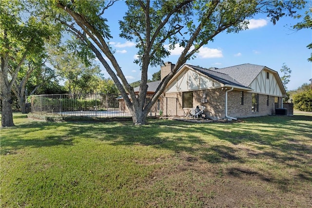 exterior space featuring a pool and a lawn