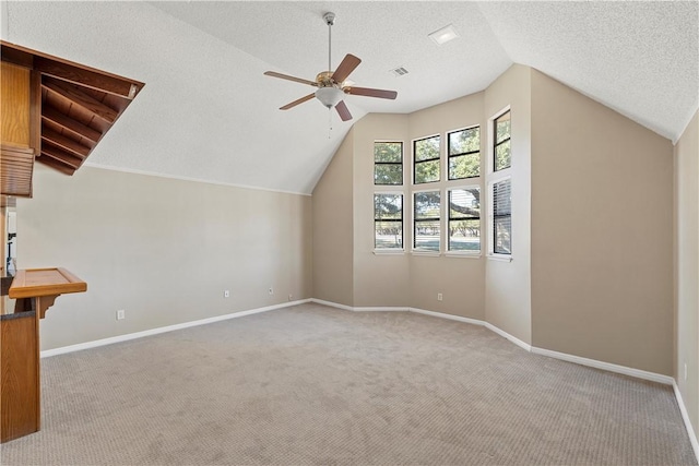 bonus room with a textured ceiling, light carpet, and lofted ceiling