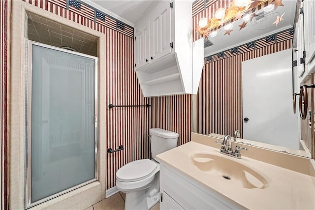 bathroom with tile patterned floors, vanity, toilet, and a shower with door