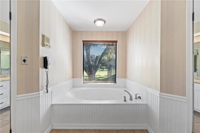 bathroom featuring a tub to relax in, tile patterned flooring, and vanity