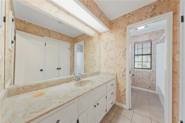 bathroom with tile patterned floors and vanity