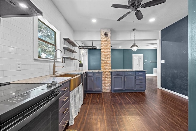 kitchen featuring wall chimney exhaust hood, dark hardwood / wood-style floors, light stone countertops, and hanging light fixtures