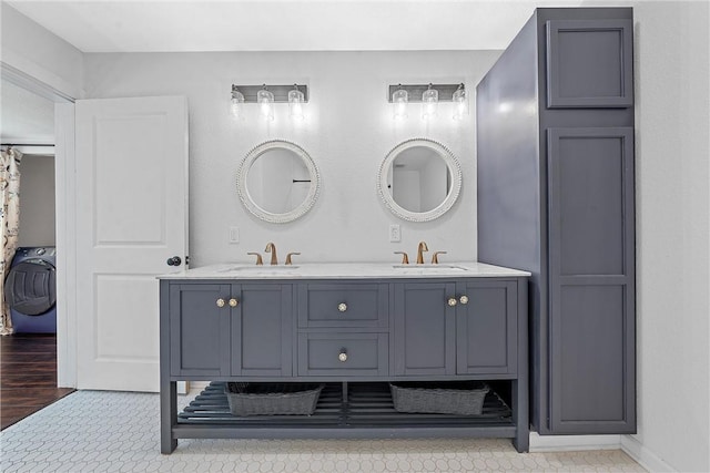 bathroom featuring hardwood / wood-style floors, vanity, and washer / dryer