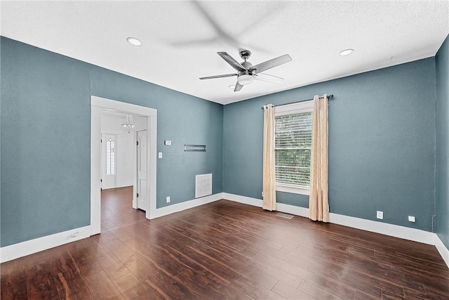 unfurnished room featuring a textured ceiling, dark hardwood / wood-style floors, and ceiling fan