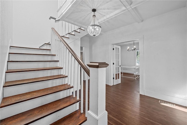 staircase with coffered ceiling, beam ceiling, wood-type flooring, and a chandelier