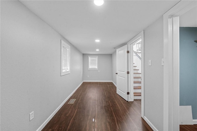 corridor with dark wood-type flooring