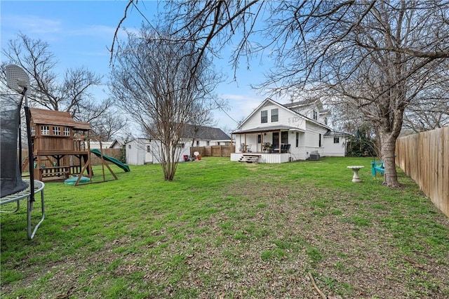 view of yard featuring a playground, a shed, and a trampoline