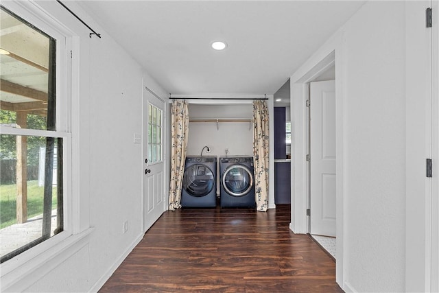 laundry room featuring washer and clothes dryer and dark wood-type flooring