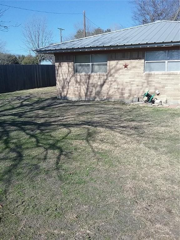 view of side of home featuring a yard