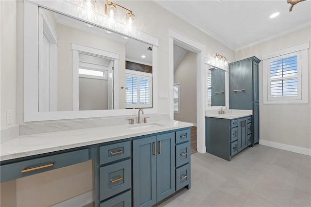 bathroom with ornamental molding, vanity, and a wealth of natural light