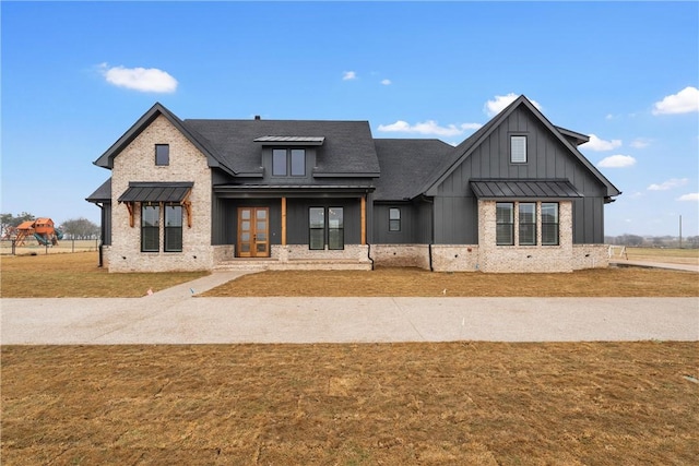 modern inspired farmhouse with a front yard