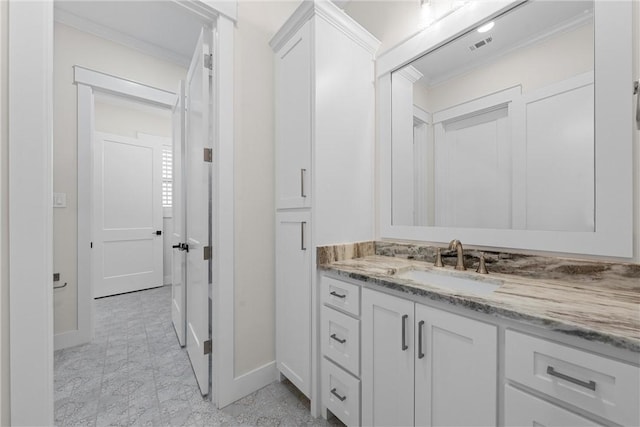 bathroom featuring ornamental molding and vanity