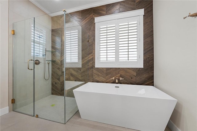 bathroom featuring ornamental molding and independent shower and bath