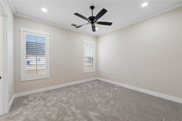 carpeted empty room with ornamental molding and ceiling fan