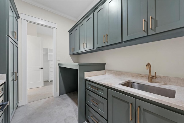 kitchen with sink, gray cabinets, and ornamental molding