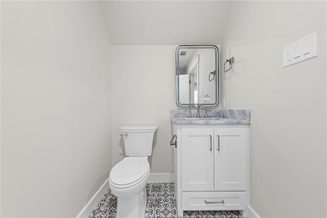 bathroom featuring tile patterned floors, vanity, and toilet