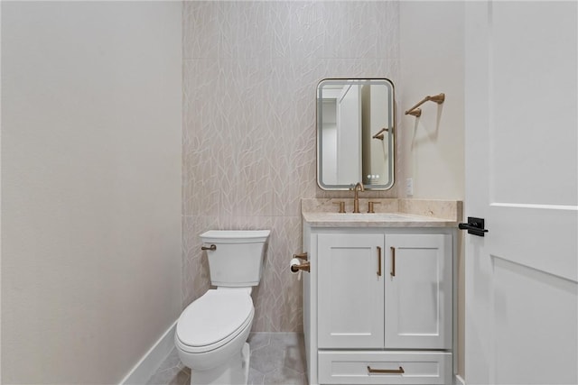 bathroom with tile patterned floors, vanity, and toilet