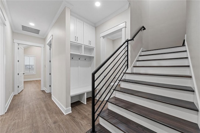 interior space with hardwood / wood-style flooring and ornamental molding