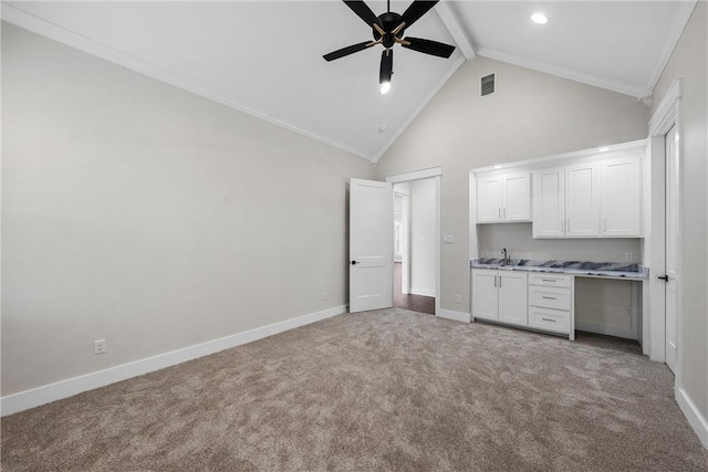 kitchen featuring high vaulted ceiling, white cabinets, ceiling fan, light carpet, and beam ceiling