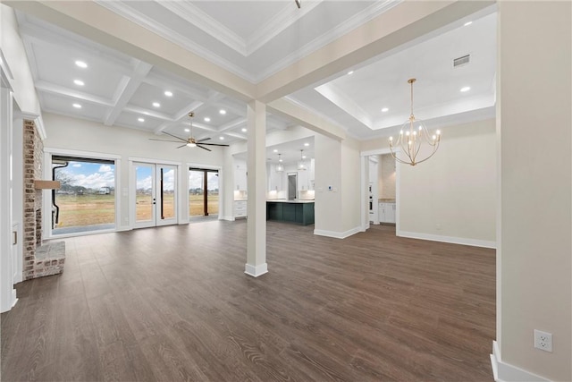 unfurnished living room featuring ceiling fan with notable chandelier, beamed ceiling, ornamental molding, coffered ceiling, and dark wood-type flooring