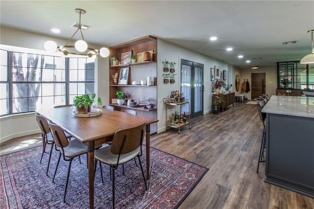 dining room featuring dark wood finished floors, an inviting chandelier, recessed lighting, and visible vents