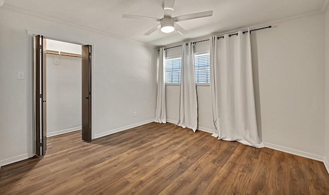 unfurnished bedroom with baseboards, a ceiling fan, wood finished floors, and crown molding